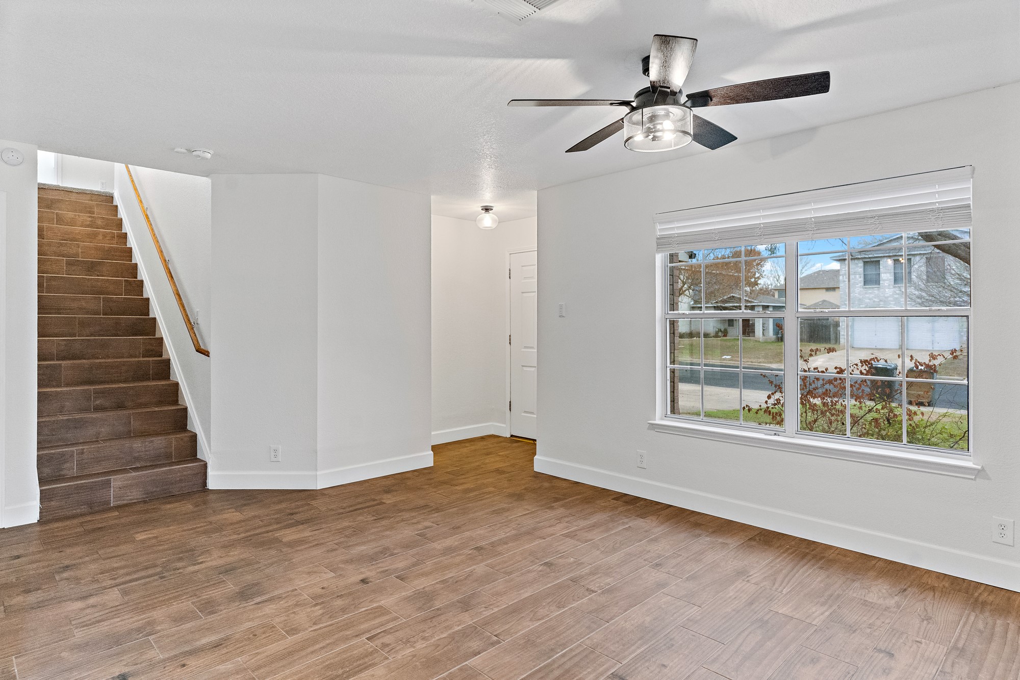 321 Nicole Way Bastrop, TX 78602 - Photo 10 of 32 Unfurnished living room with light wood-type flooring and ceiling fan