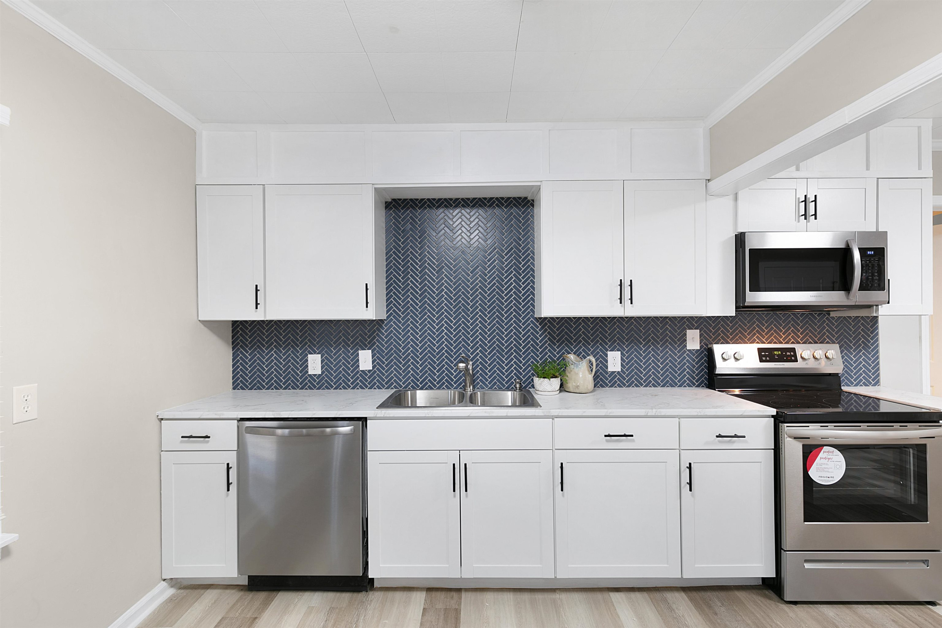 28 Oak Grove Road Jackson, TN 38301 - Photo 5 of 21 a kitchen with white cabinets and white appliances