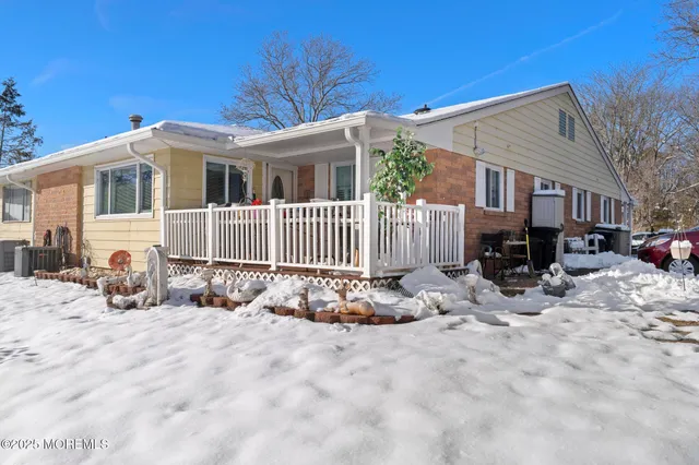 a view of a house with a yard covered in snow