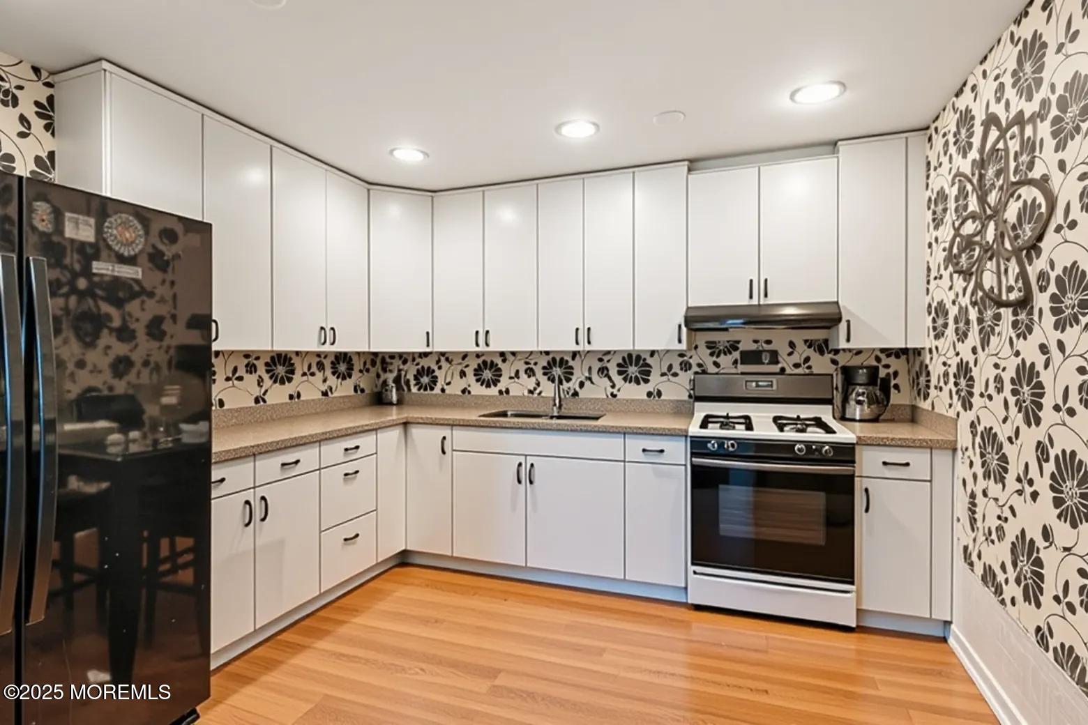 6 C Swallow Street Jackson, NJ 08527 - Photo 6 of 12 a kitchen with stainless steel appliances granite countertop a stove a sink and a refrigerator