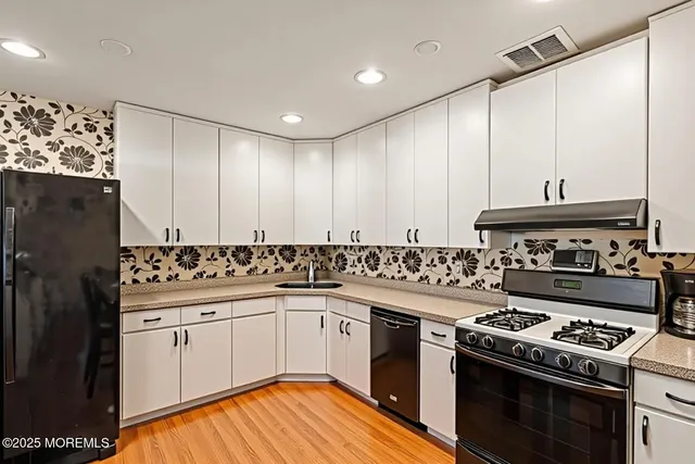 a kitchen with a stove top oven sink and cabinets