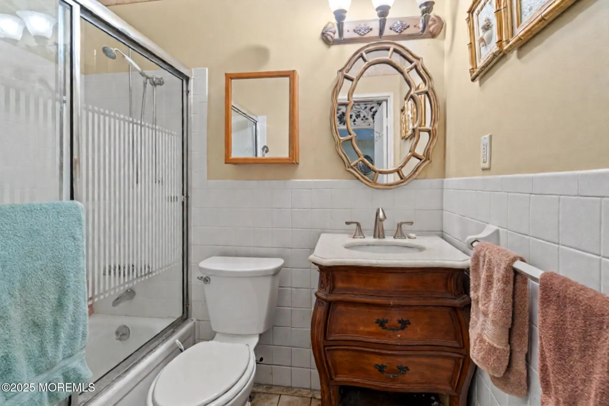 6 C Swallow Street Jackson, NJ 08527 - Photo 10 of 12 a bathroom with a sink a toilet and a mirror