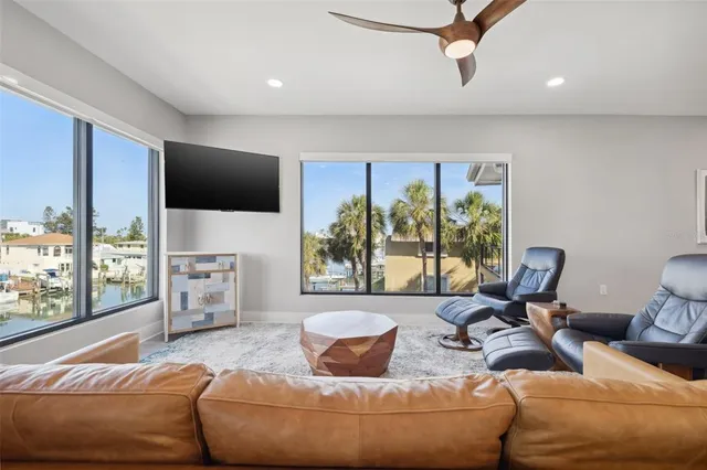 a kitchen with stainless steel appliances kitchen island granite countertop a table chairs microwave and sink