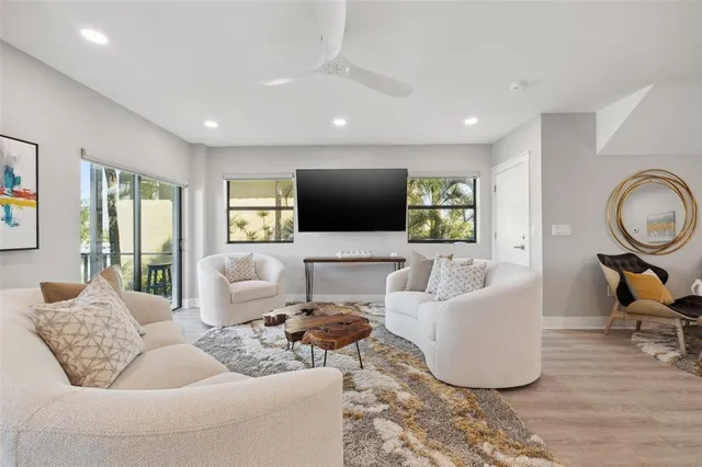 a spacious bedroom with a bed and a lamp on table