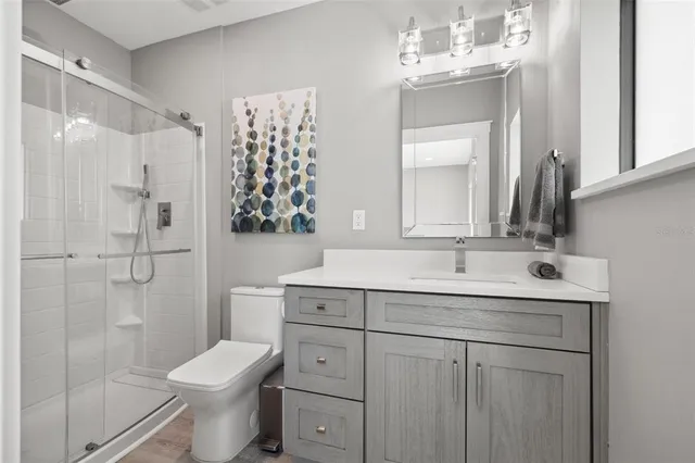 a bathroom with a toilet a sink and a mirror