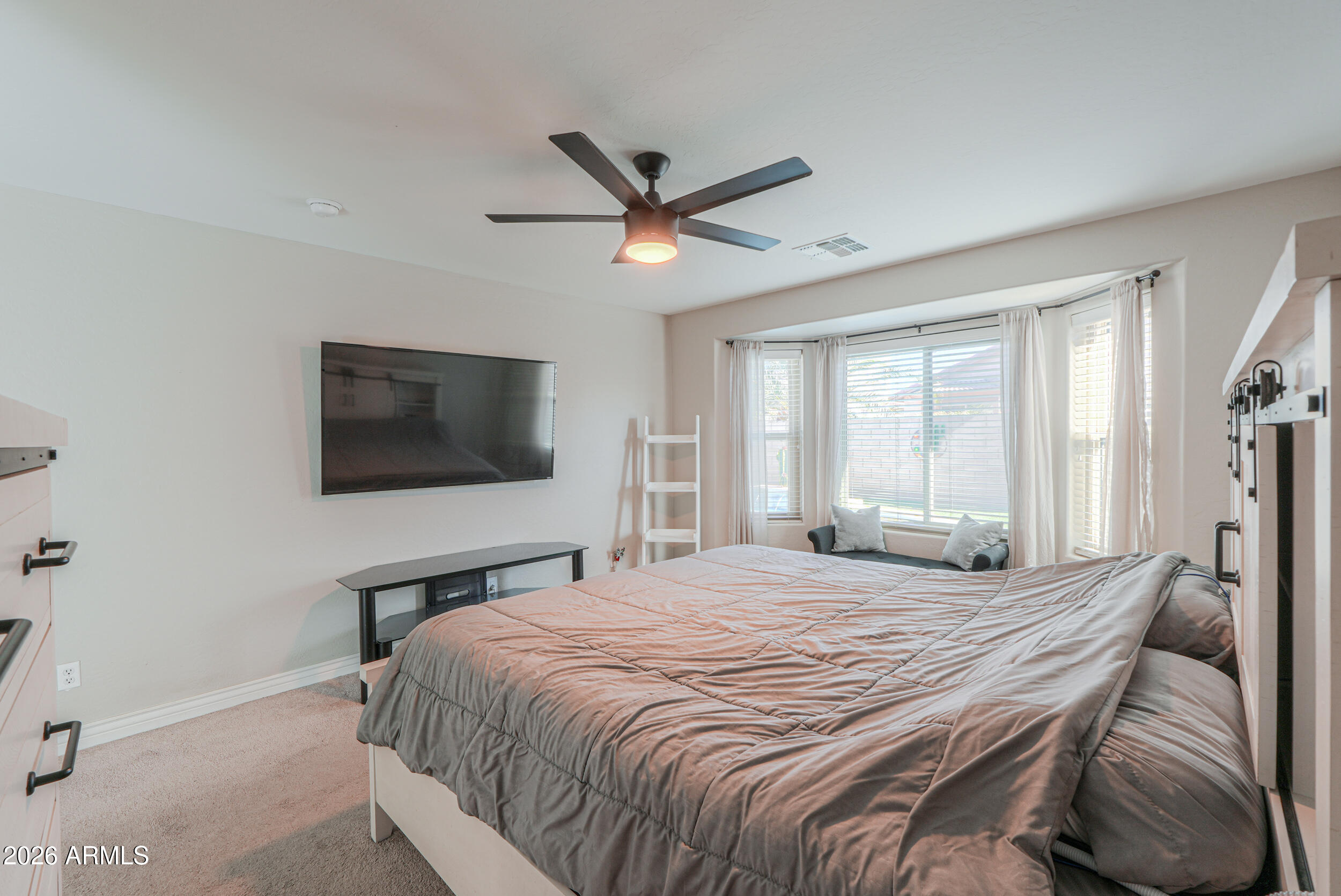 43843 Roth Road Maricopa, AZ 85138 - Photo 34 of 53 a bedroom with a large bed and a tv