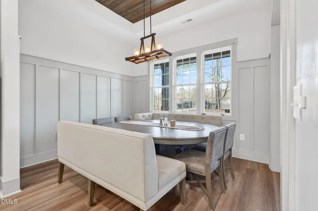 a large kitchen with a large counter top space a sink stainless steel appliances and cabinets