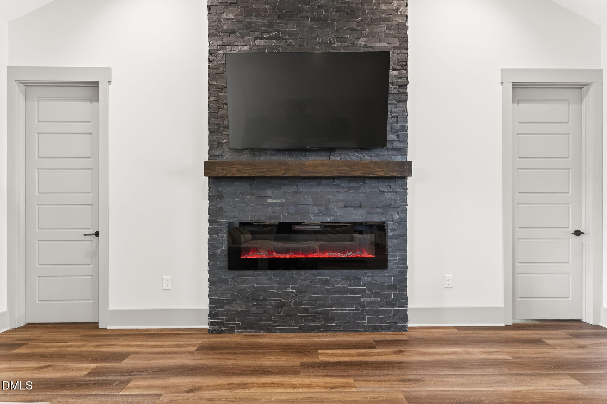 260 Freedom Road Smithfield, NC 27577 - Photo 30 of 75 a living room with a fireplace and a flat screen tv