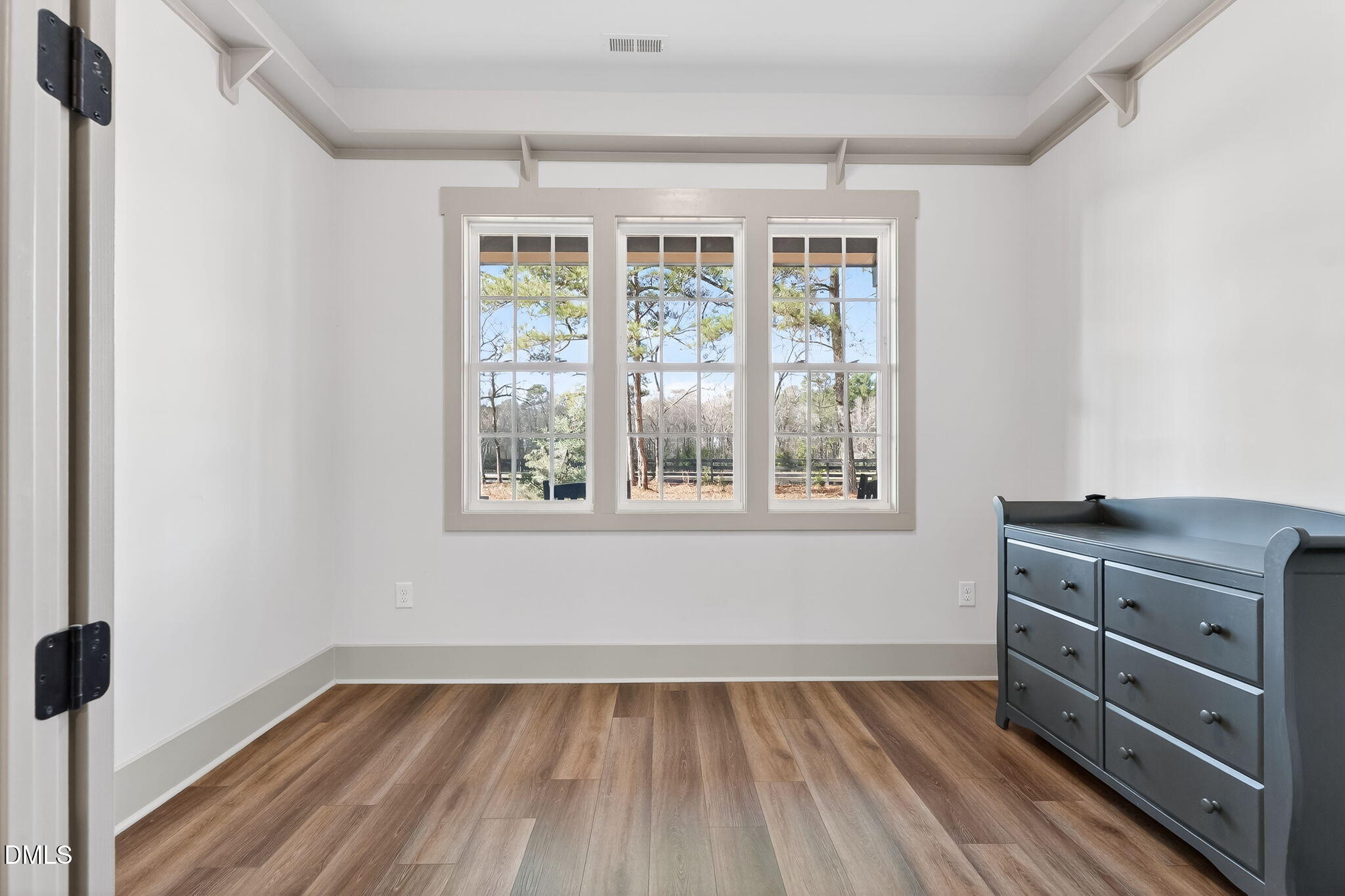 260 Freedom Road Smithfield, NC 27577 - Photo 31 of 75 a view of an empty room with a window and wooden floor