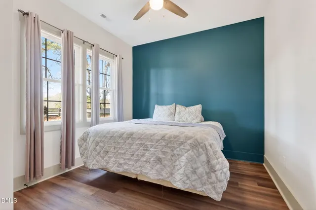 a view of a room with wooden floor and white walls