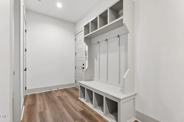 an aerial view of residential houses with outdoor space and trees