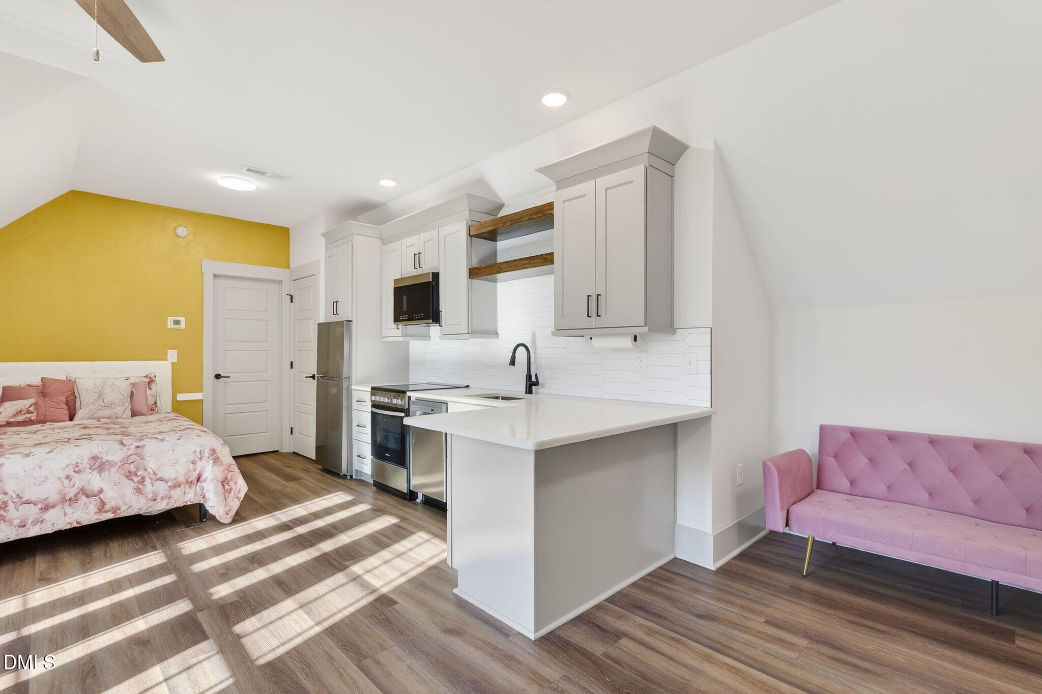 260 Freedom Road Smithfield, NC 27577 - Photo 52 of 75 a spacious bedroom with a bed and a couch
