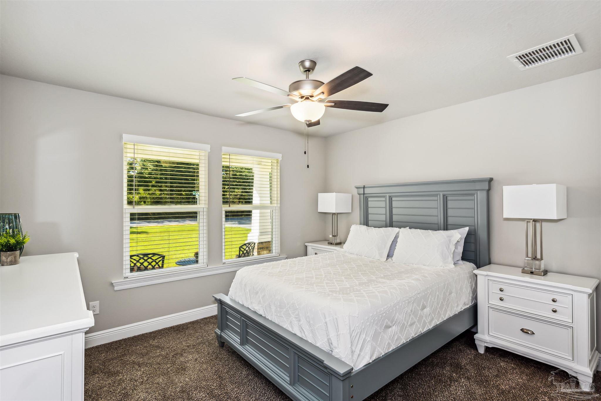 4835 Horace Lunsford Road Milton, FL 32570 - Photo 15 of 20 a bedroom with a bed and a window