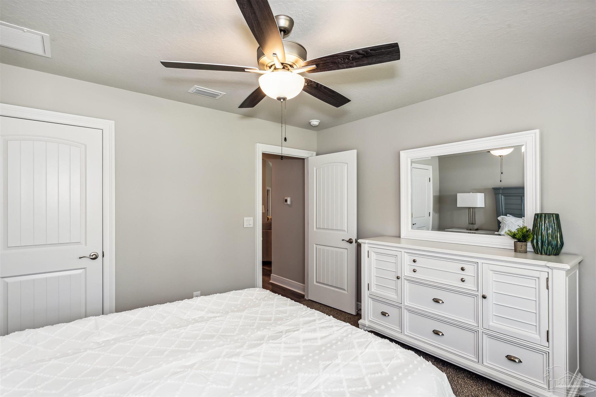 4835 Horace Lunsford Road Milton, FL 32570 - Photo 16 of 20 a bedroom with a large bed and a chandelier