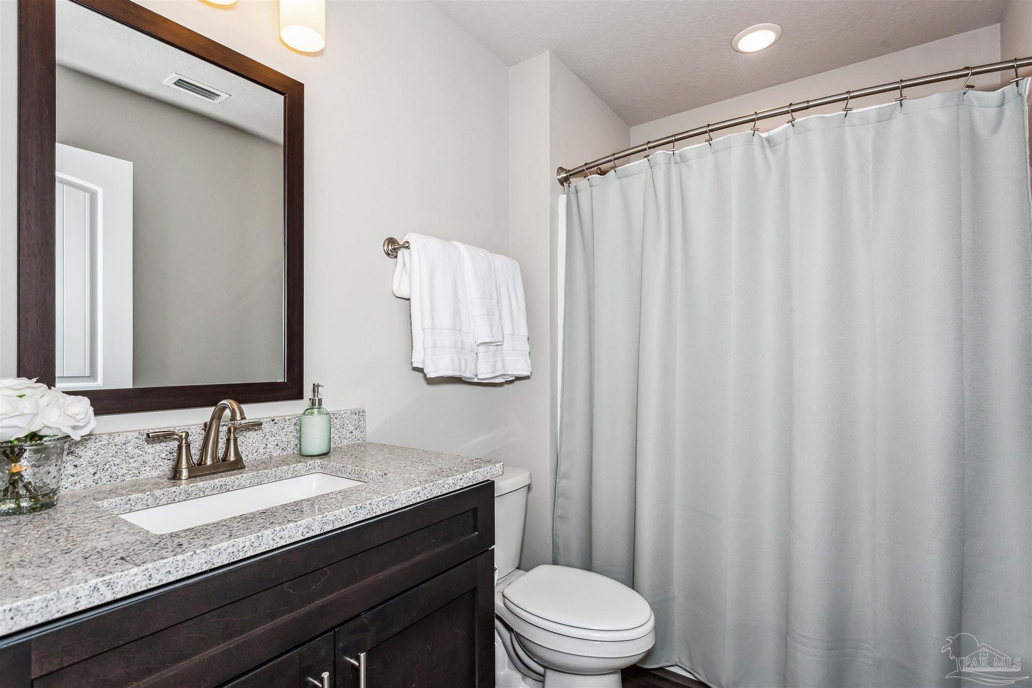 4835 Horace Lunsford Road Milton, FL 32570 - Photo 19 of 20 a bathroom with a granite countertop sink and a mirror