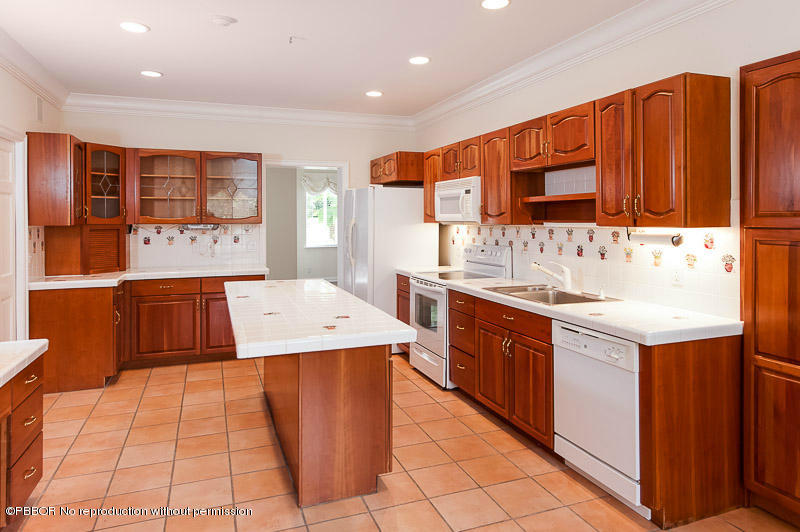 275 North County Road Palm Beach, FL 33480 - Photo 7 of 15 a kitchen with a sink stove and cabinets
