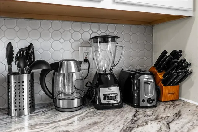 a storage room with water heater and wooden cabinets