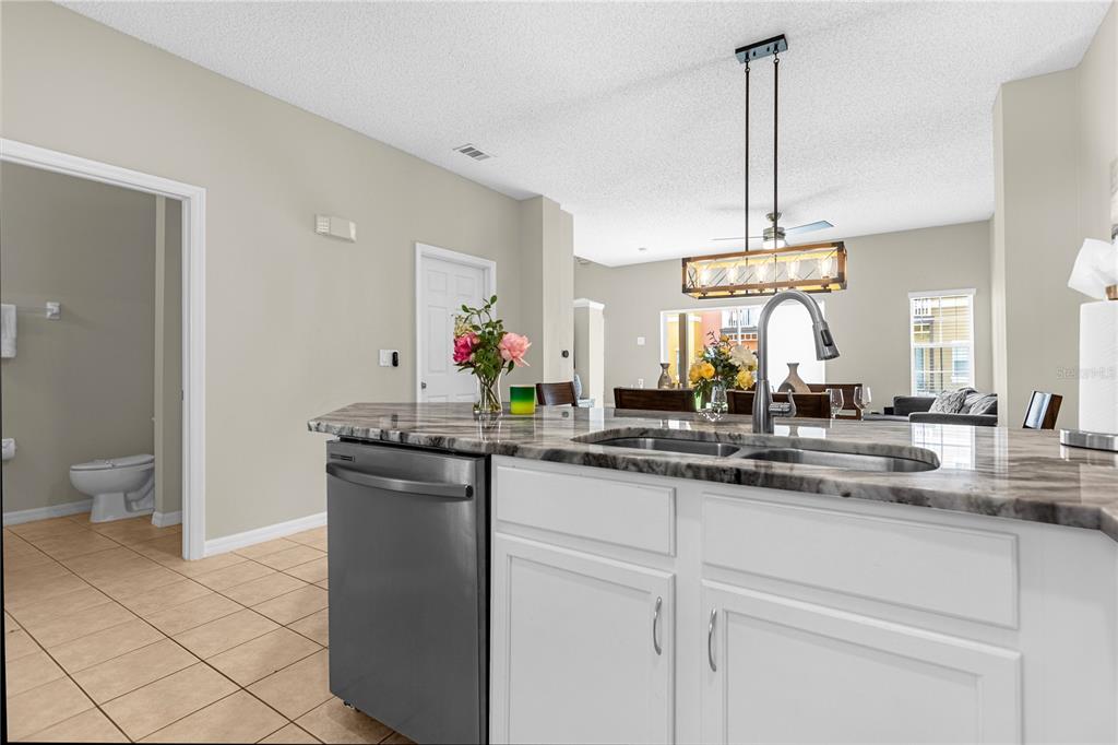 8558 Crystal Cove Loop Kissimmee, FL 34747 - Photo 14 of 35 a kitchen with a sink and stove