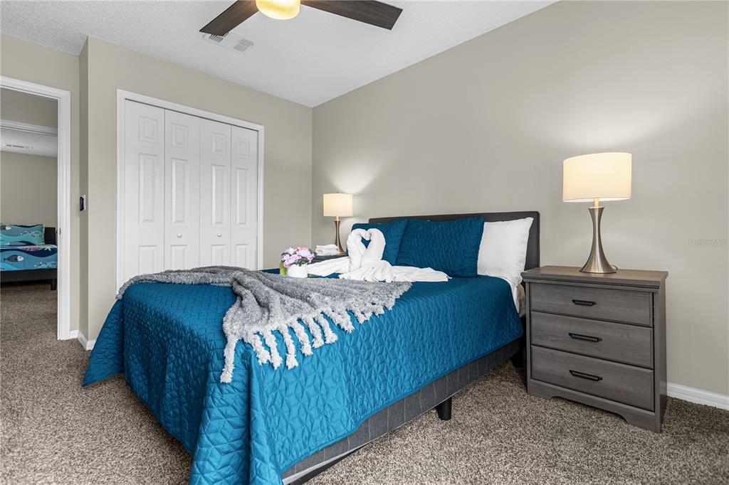 8558 Crystal Cove Loop Kissimmee, FL 34747 - Photo 20 of 35 a bedroom with a bed and a lamp
