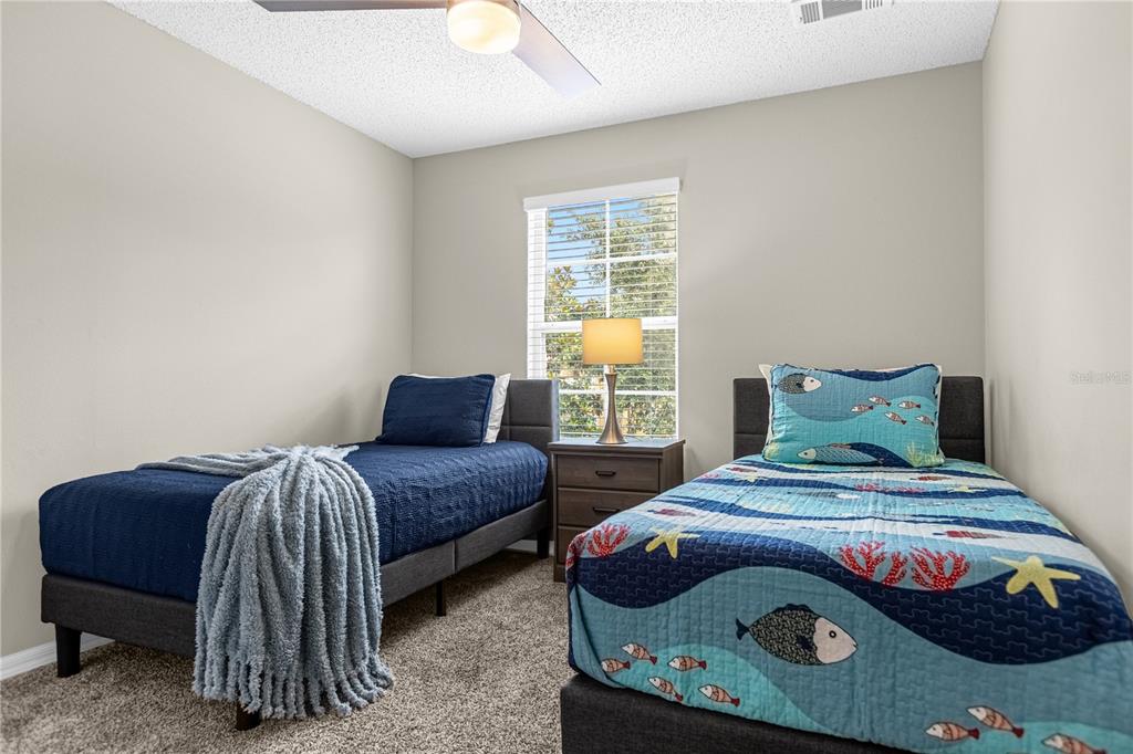 8558 Crystal Cove Loop Kissimmee, FL 34747 - Photo 25 of 35 a bedroom with a bed and a window