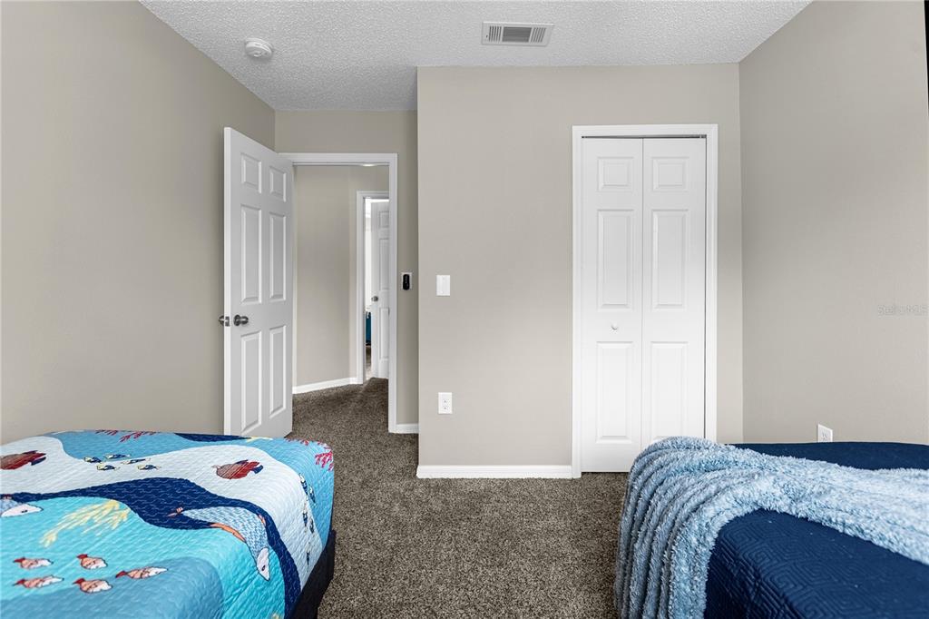8558 Crystal Cove Loop Kissimmee, FL 34747 - Photo 27 of 35 a bedroom with a bed and a closet