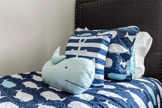 a large bed sitting in a bedroom next to a window and a mirror