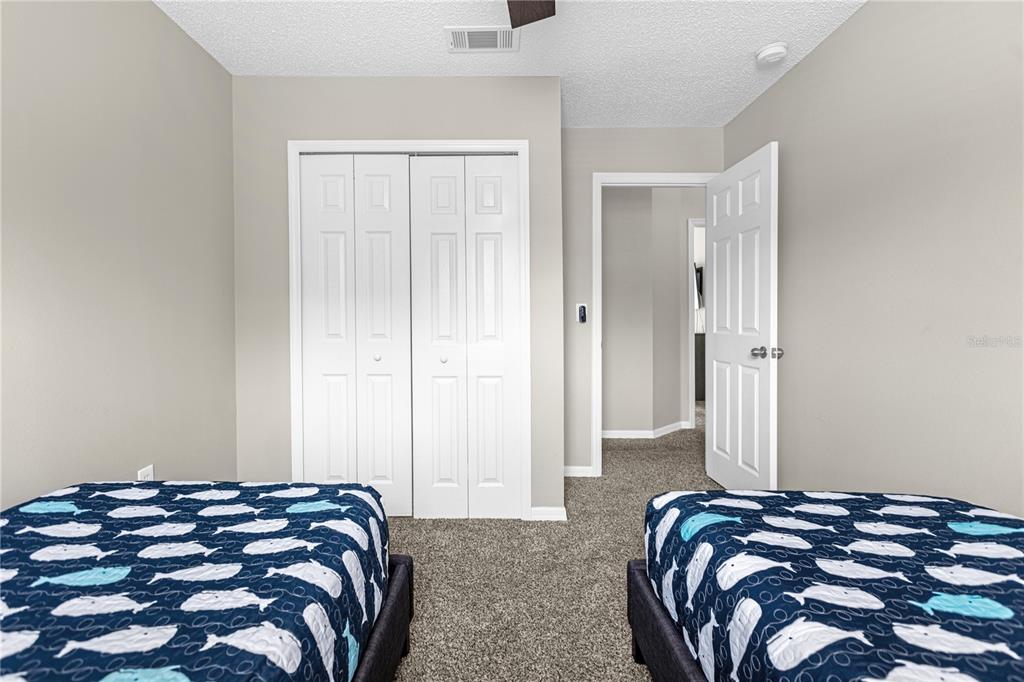 8558 Crystal Cove Loop Kissimmee, FL 34747 - Photo 30 of 35 a bedroom with a bed and a window