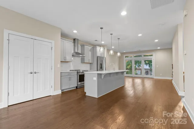 a large white kitchen with a large window