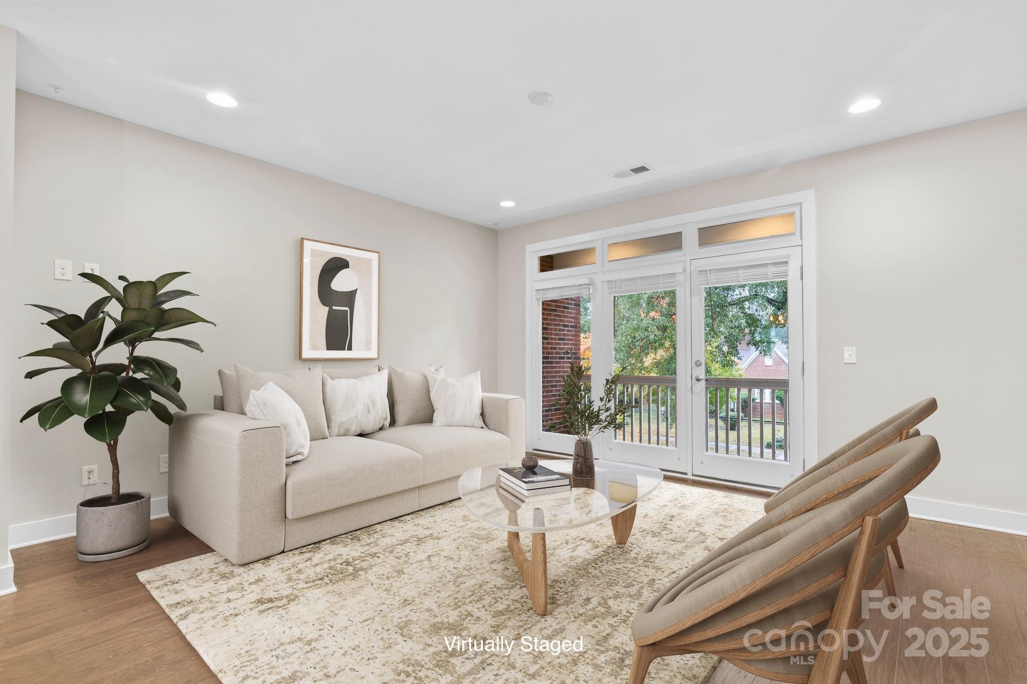 129 Grandin Road Charlotte, NC 28208 - Photo 15 of 35 a living room with furniture potted plant and a large window