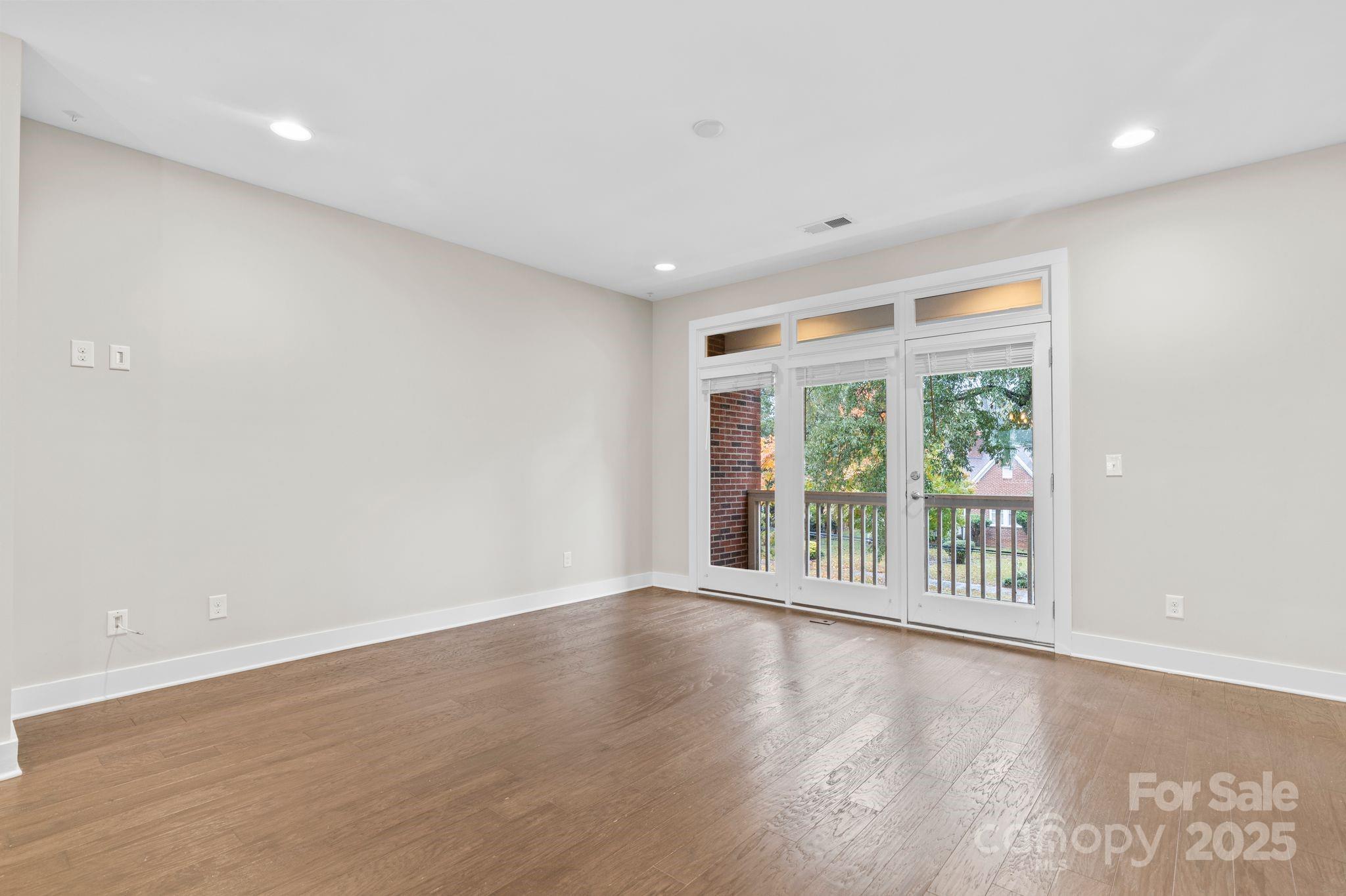 129 Grandin Road Charlotte, NC 28208 - Photo 16 of 35 a view of an empty room with wooden floor and a window