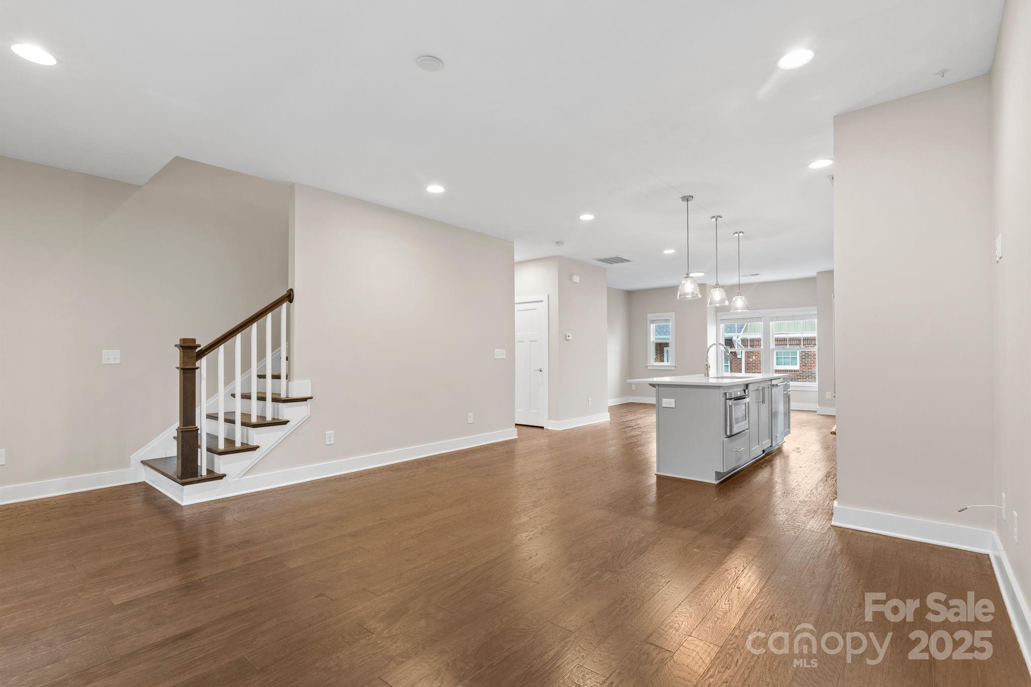 129 Grandin Road Charlotte, NC 28208 - Photo 18 of 35 a view of kitchen and an empty room with wooden floor