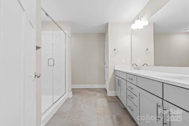 a bathroom with a double vanity sink and a mirror
