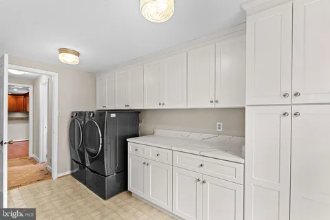 a view white cabinets and washer dryer