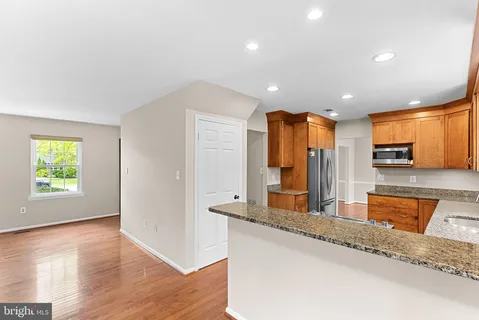 a kitchen with stainless steel appliances granite countertop a sink and a granite counter tops