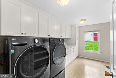 a view of a kitchen with washing machine and washing machine