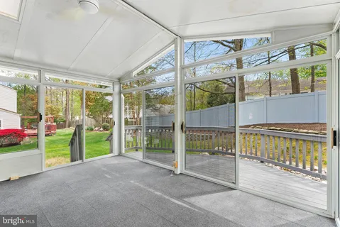 a view of a house with a small yard plants and large trees