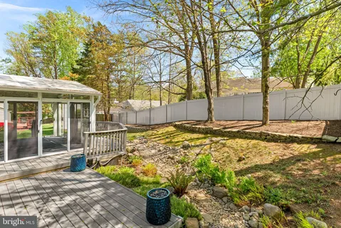 a view of a house with a large tree and a yard