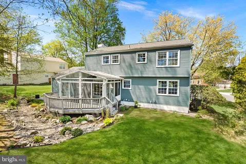 a view of a backyard with table and chairs and wooden fence