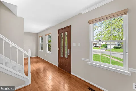 a view of an entryway with wooden floor and windows