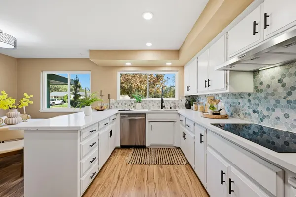 a kitchen with a sink appliances and a living room