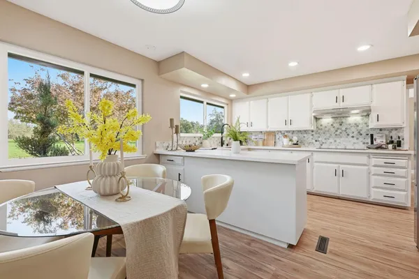 a dining room with furniture and a window