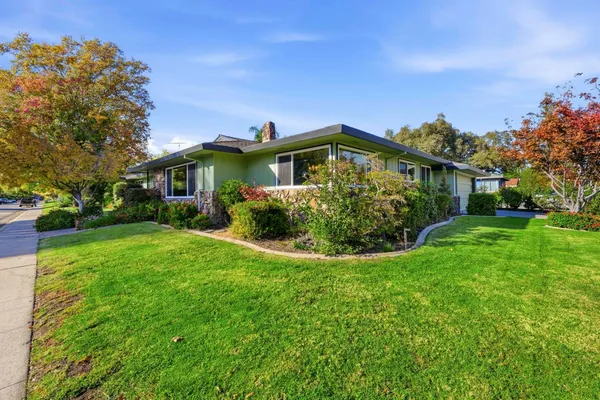 a front view of a house with garden
