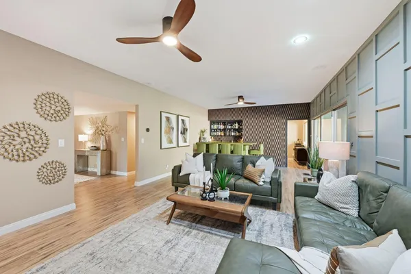 a dining room with furniture and wooden floor