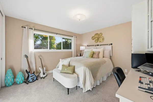 a bedroom with a bed chair and a window