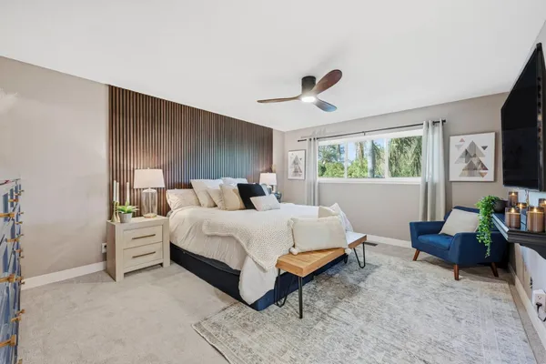 a bedroom with a bed and a flat screen tv