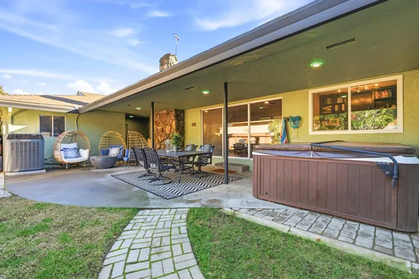 a view of a patio with table and chairs with wooden fence