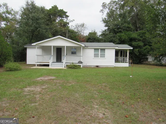 a front view of house with yard and trees