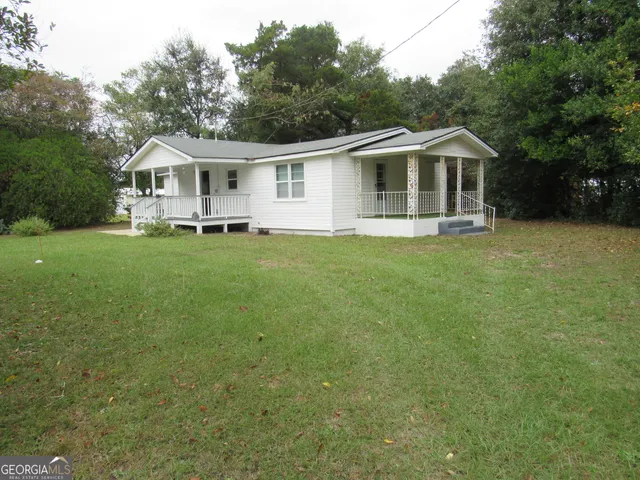 a aerial view of a house with a yard table and chairs