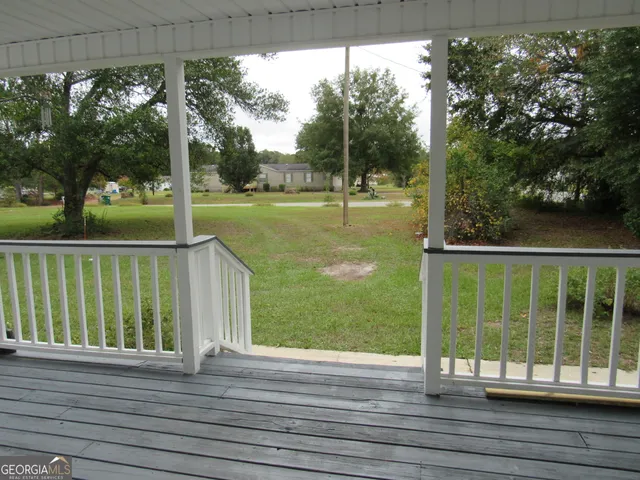 a view of a kitchen with a sink and a refrigerator