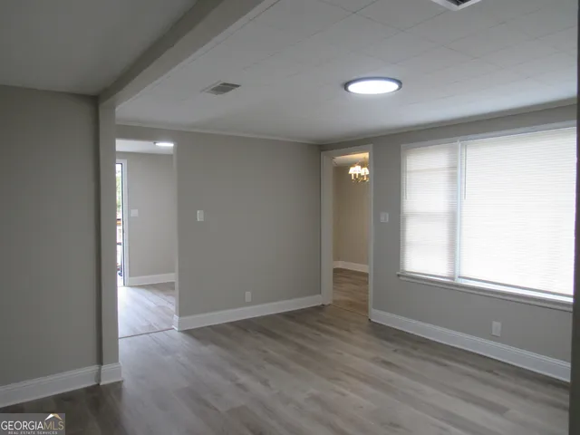 a kitchen with granite countertop a sink a stove and cabinets